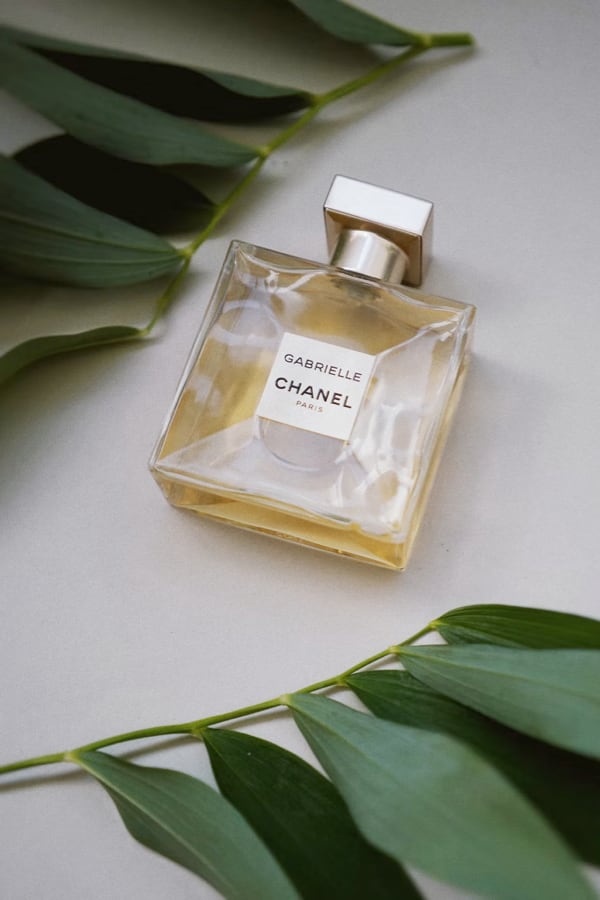 bottle of parfume by chanel with green leaves