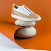 Preview picture of white beige sneakers on an orange background