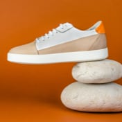 Preview picture of white beige sneakers on an orange background